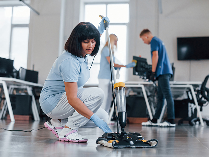 vecteezy_woman-uses-vacuum-cleaner-group-of-workers-clean-modern_16728296.webp